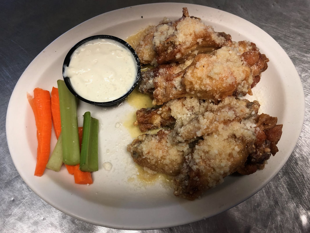 garlic parmesan wings with blue cheese and carrots at Jades Bar Restaurant in Depew, New York